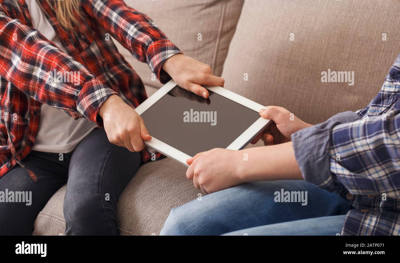 Unrecognizable Greedy Kids Not Wanting To Share Tablet Computer Indoor Stock Photo