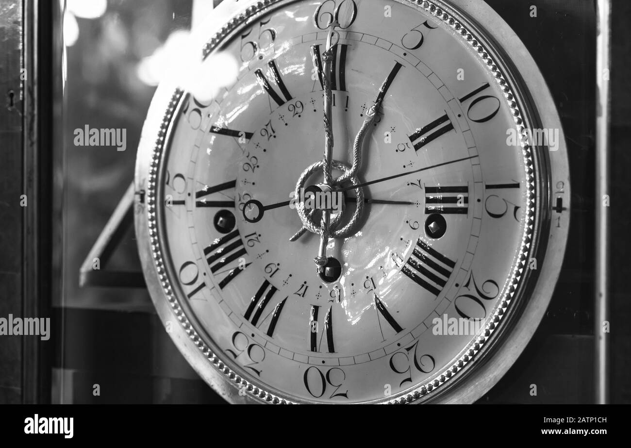 Vintage grandfather clock with white dial. Black and white close-up photo Stock Photo