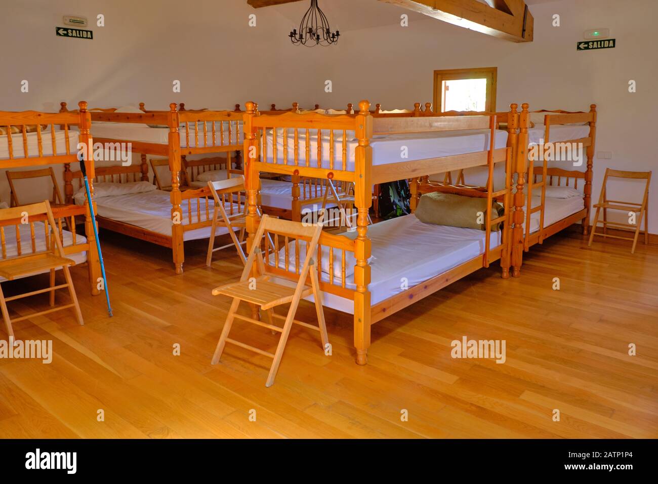 Inside of a pilgrim hostel dormitory on the Camino de Santiago, with wooden bunk beds. Stock Photo