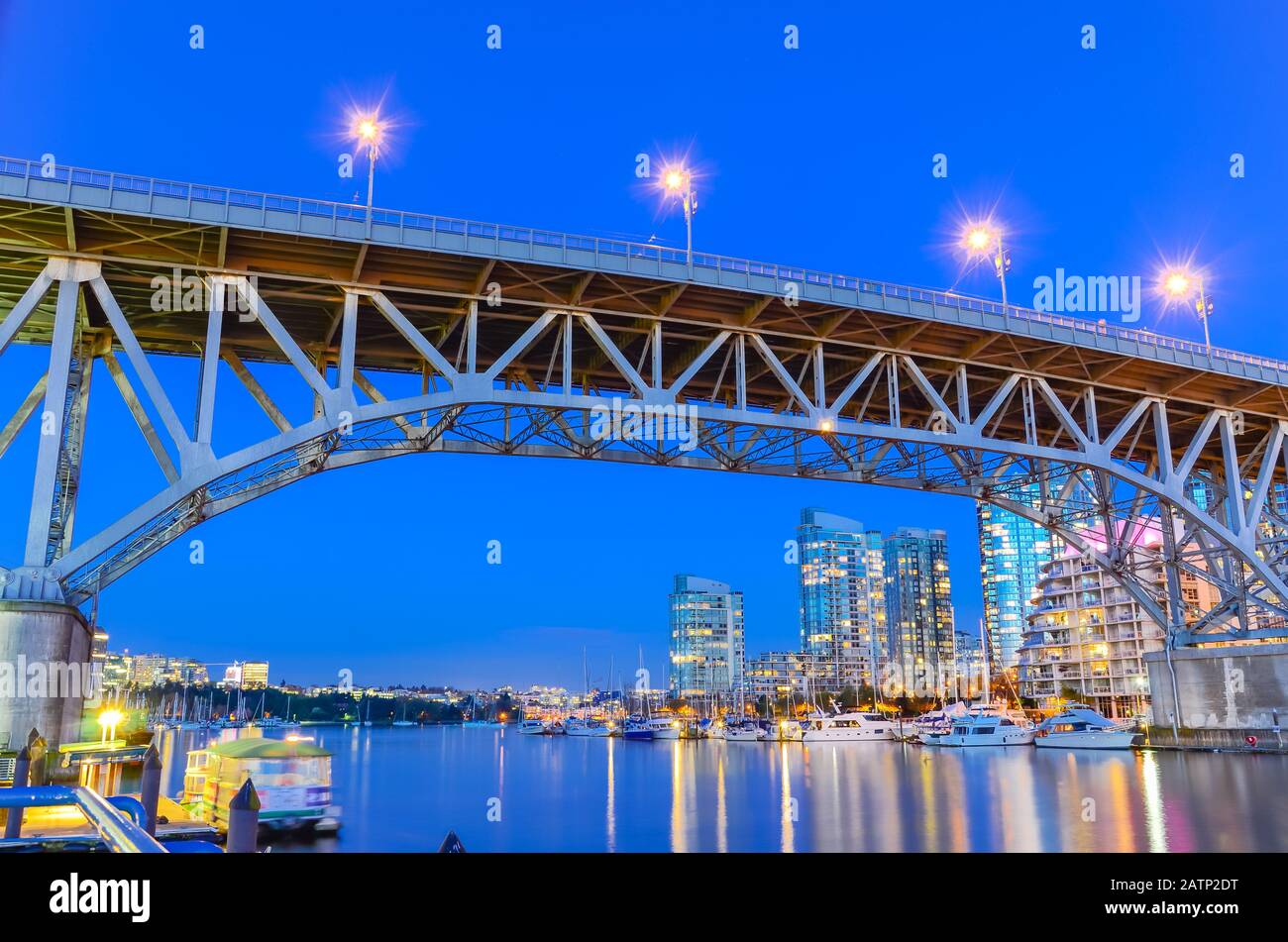 Granville Bridge and Vancouver BC skyline reflection at blue hour in