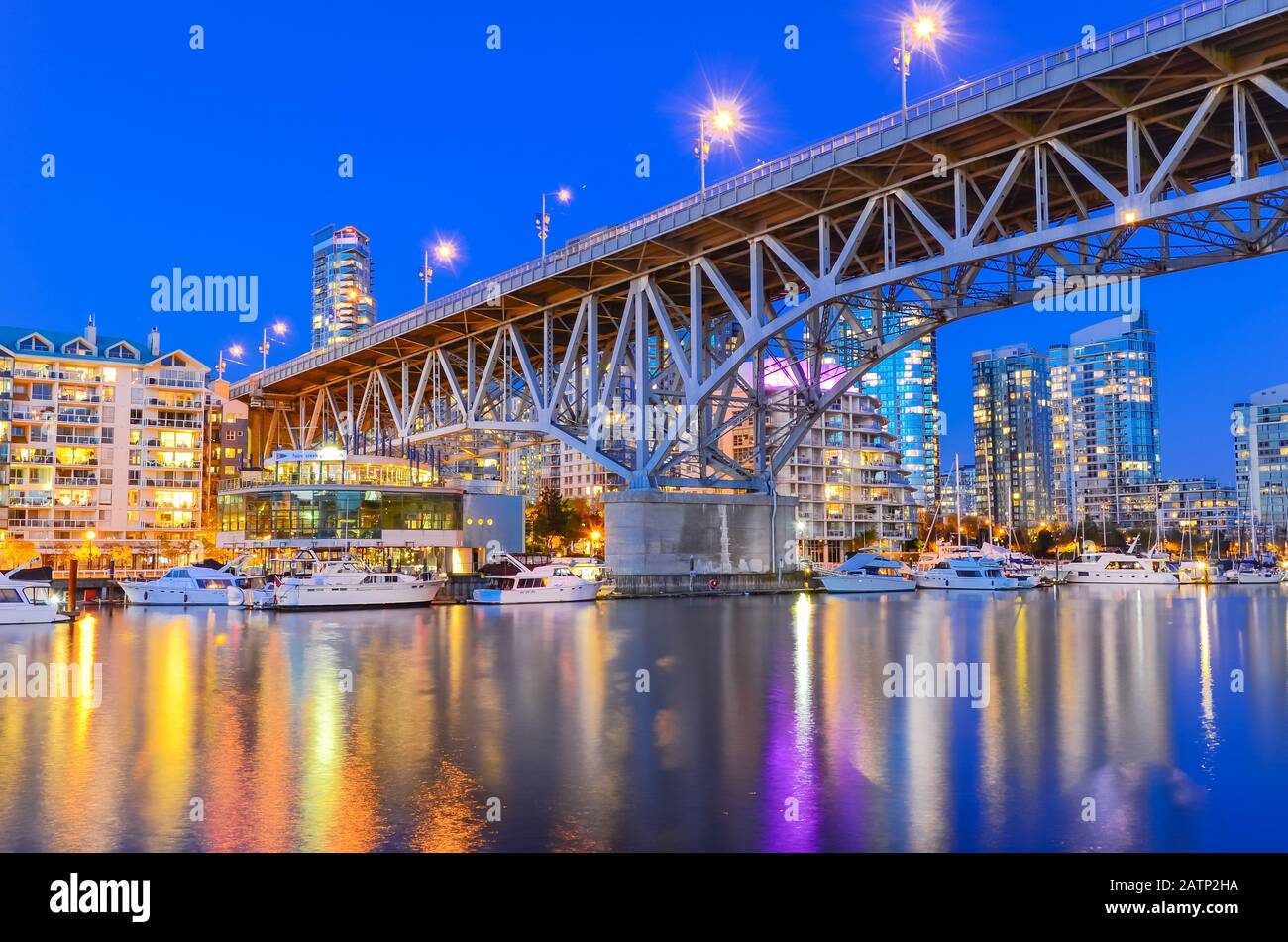 Granville Bridge and Vancouver BC skyline reflection at blue hour in