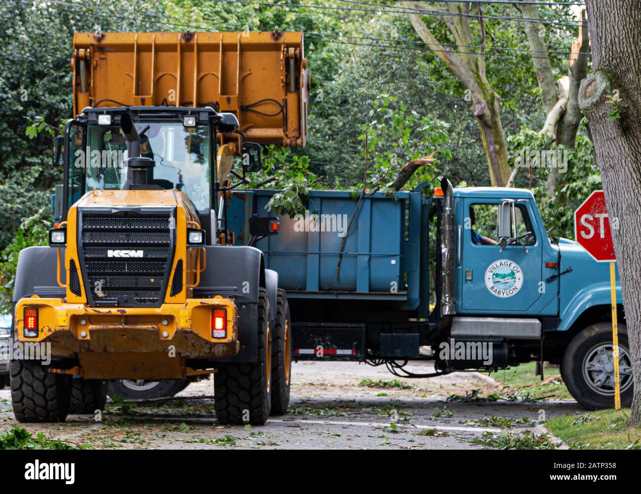 Babylon, New York, USA - 23 August 2019: Babylon Village trucks clearing a road full of trees after a hurricane and strong winds caused damge and tree Stock Photo
