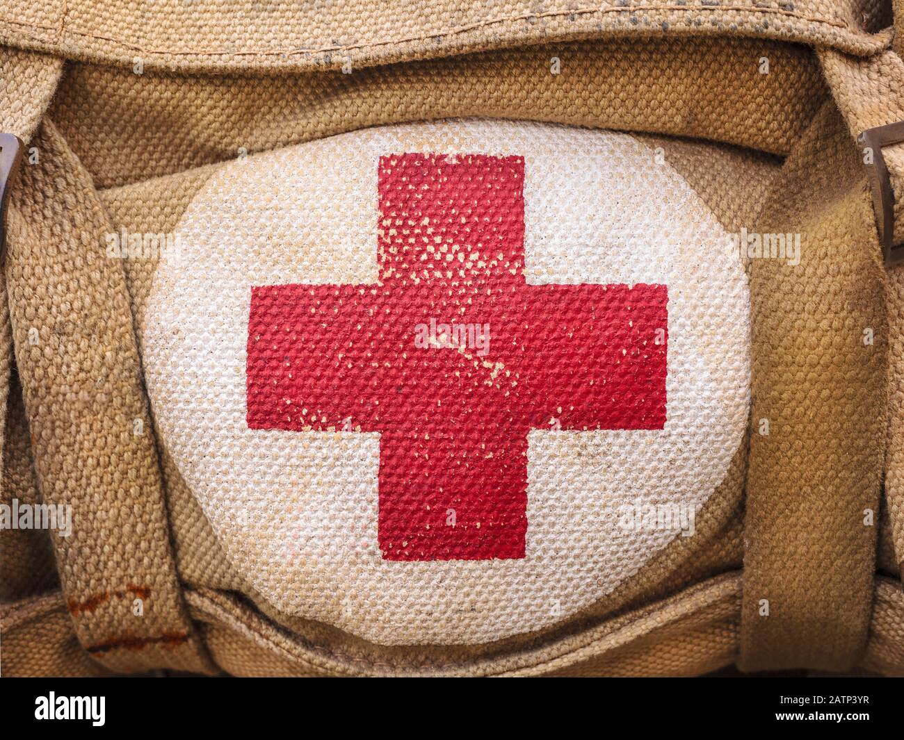 Red cross medical aid symbol on a vintage jute army bag Stock Photo - Alamy