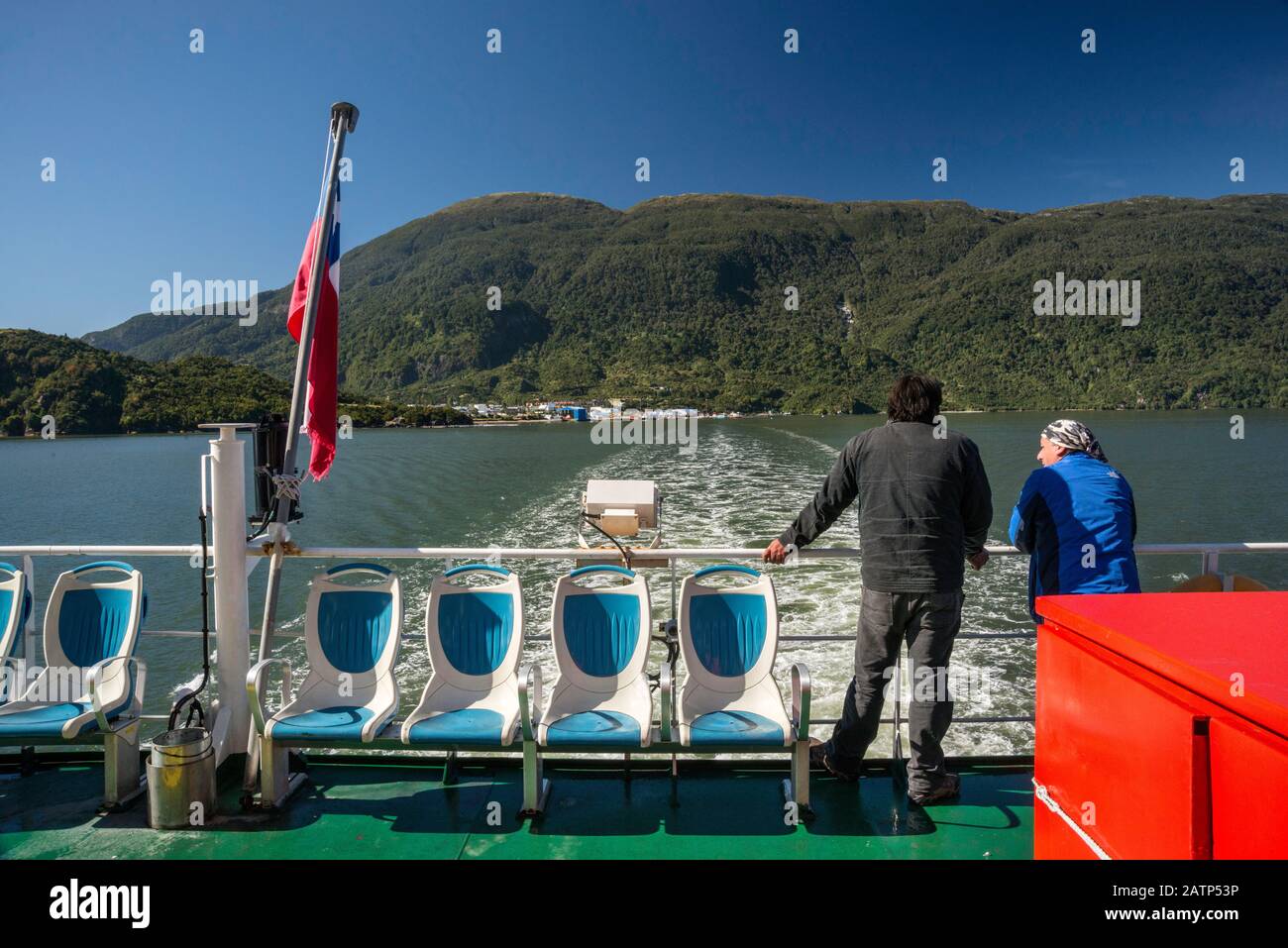 Quelat ferry leaving its wake in Aisen Fjord, Puerto Chacabuco in distance, Aysen Region, Patagonia, Chile Stock Photo