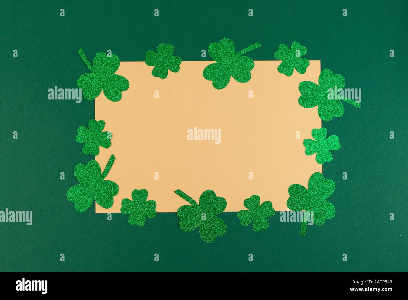 St.Patrick 's Day. Clover shamrocks frame on a green background. Copy space, flat lay Stock Photo