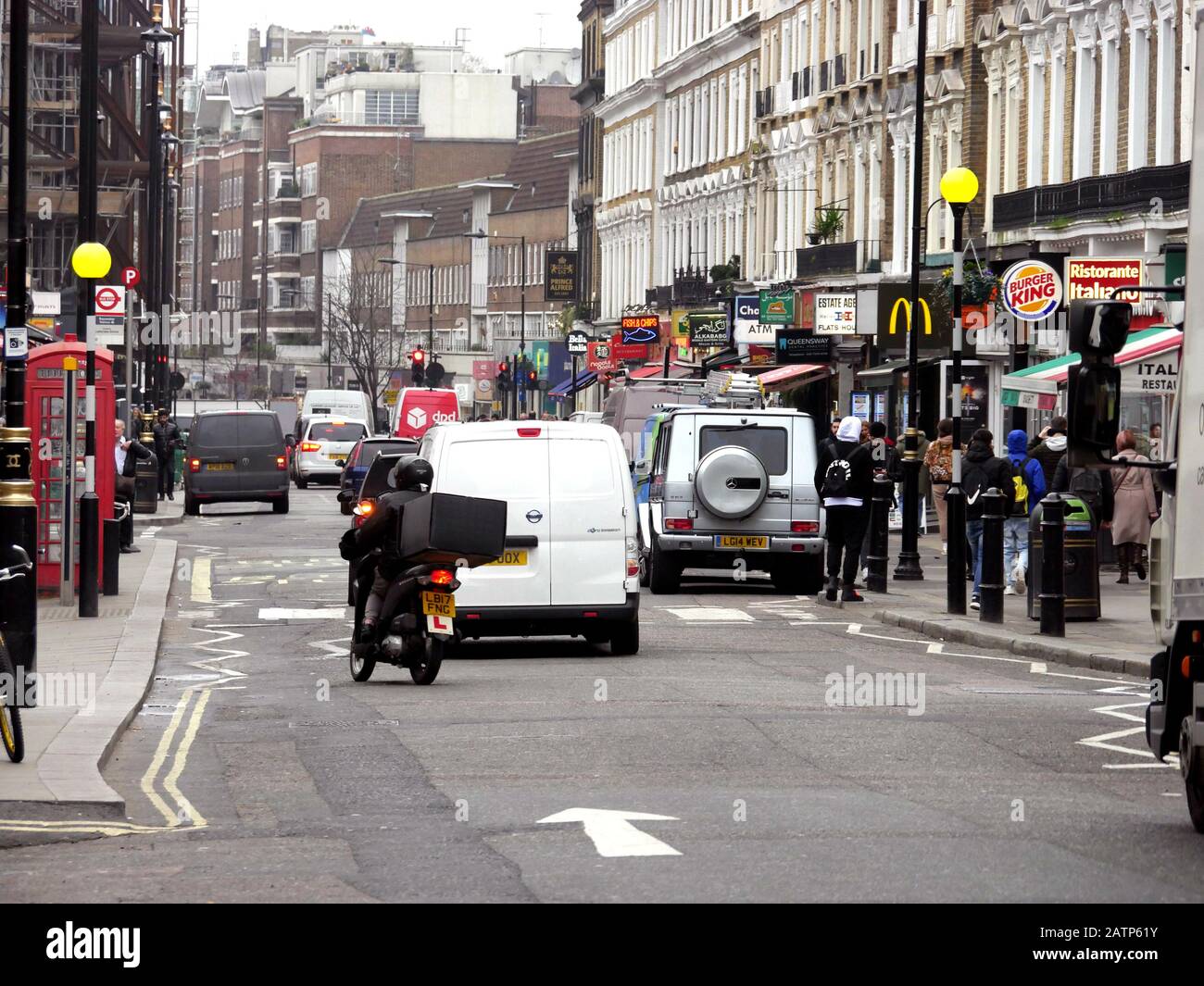 Queensway, London, UK. Busy and crowded with cars, bikes and people on a Friday afternoon Stock Photo