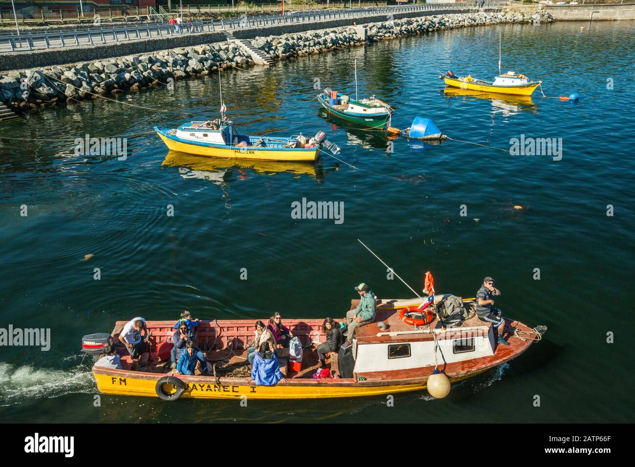 Boats at wharf in Puerto Aguirre seen from a ferry, at Isla Las Huichas