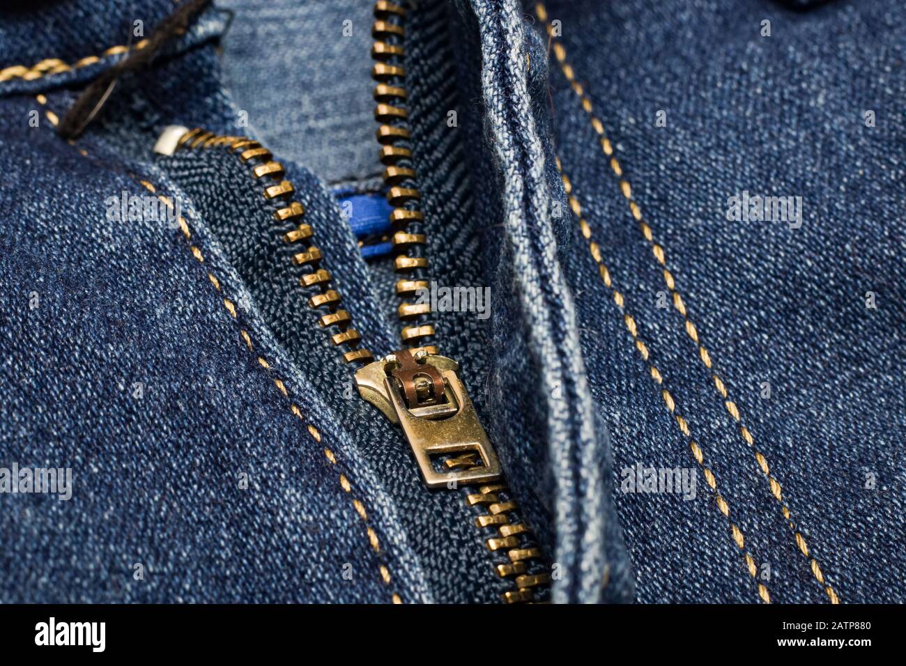 Denim texture. The background. Dark blue jeans. Jeans zipper. Pants fly  close-up. Lock, clasp, butto Stock Photo by Chibelek