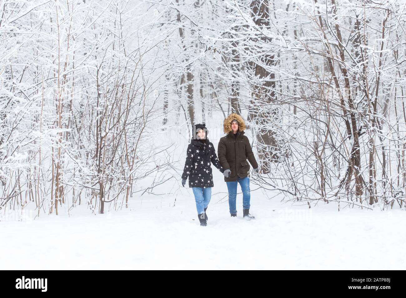 Happy loving couple having fun outdoors in snow park. Winter vacation ...