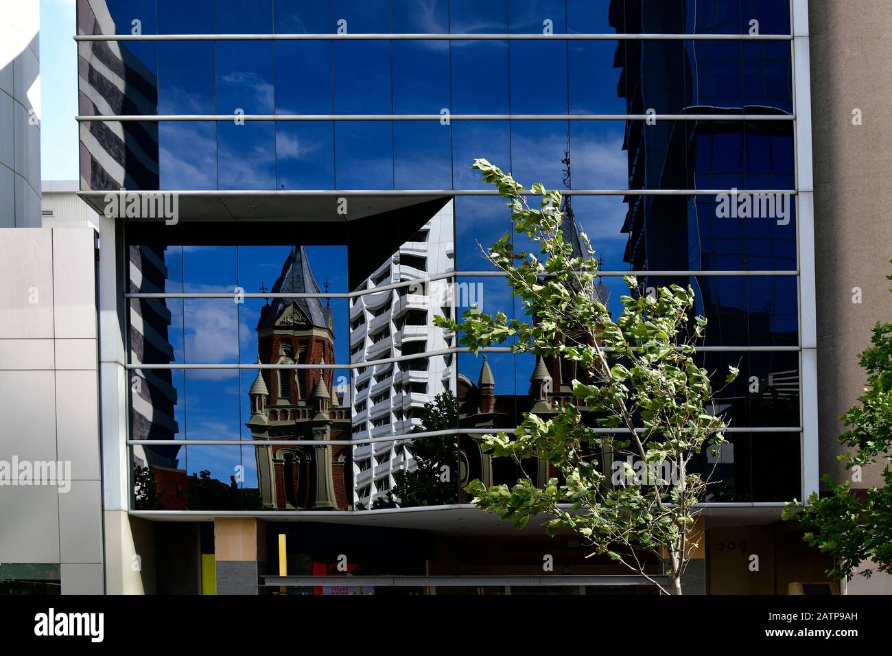 Australia, Perth, reflection of old town hall in glass facade in CBD of