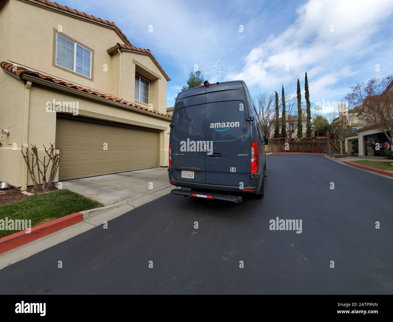 Wide angle of Mercedes Benz truck modified to serve as Amazon delivery truck with logo making deliveries on suburban street in San Ramon, California, January 27, 2020. () Stock Photo