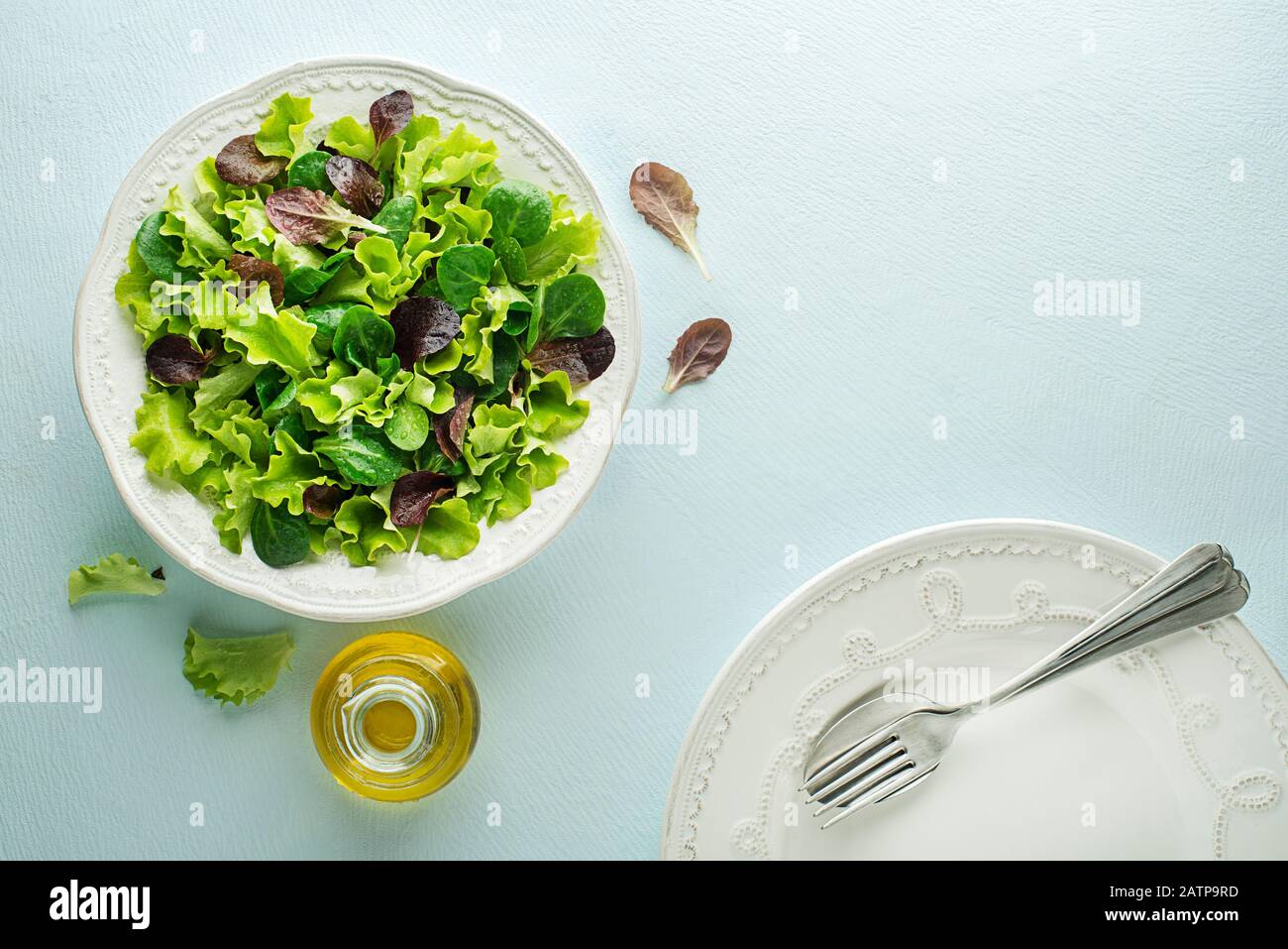 Healthy Green salad meal with fresh vegetables on blue table background Stock Photo