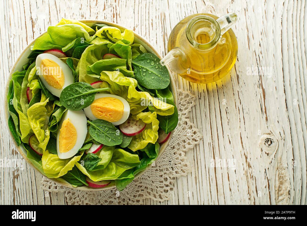 Healthy green salad with eggs on wooden table background. Healthy meal. Stock Photo