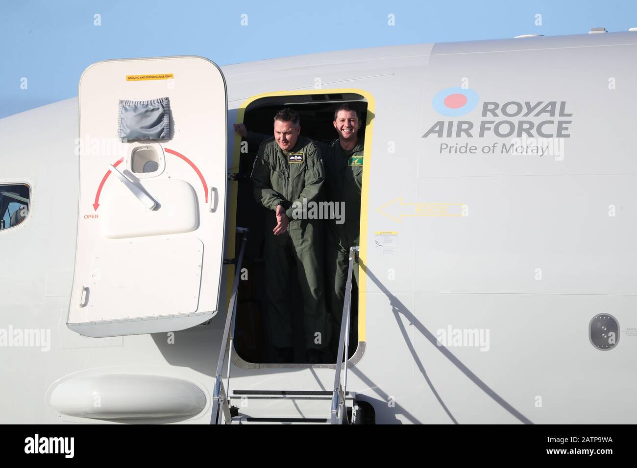 Squadron Leader Mark Faulds (left), from 54 Squadron, and Squadron Leader Dave Higgins, from 120 Squadron, look out from the UK's first submarine-hunting P-8A Poseidon maritime patrol aircraft which arrived at Kinloss Barracks in Morayshire after crossing the Atlantic from NAS Jacksonville. Stock Photo