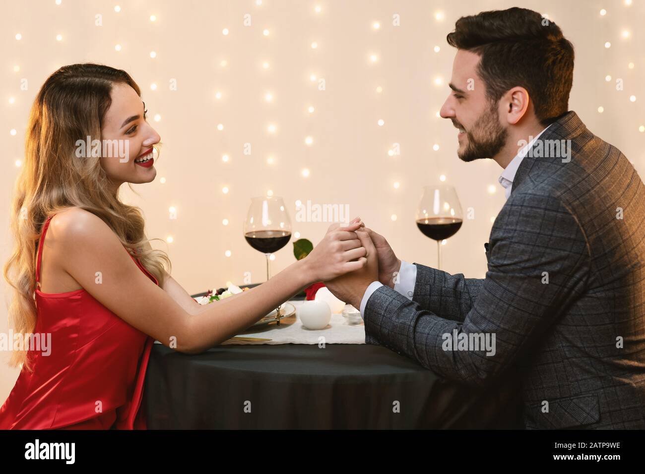 Loving Couple Holding Hands In Restaurant And Looking At Each Other ...