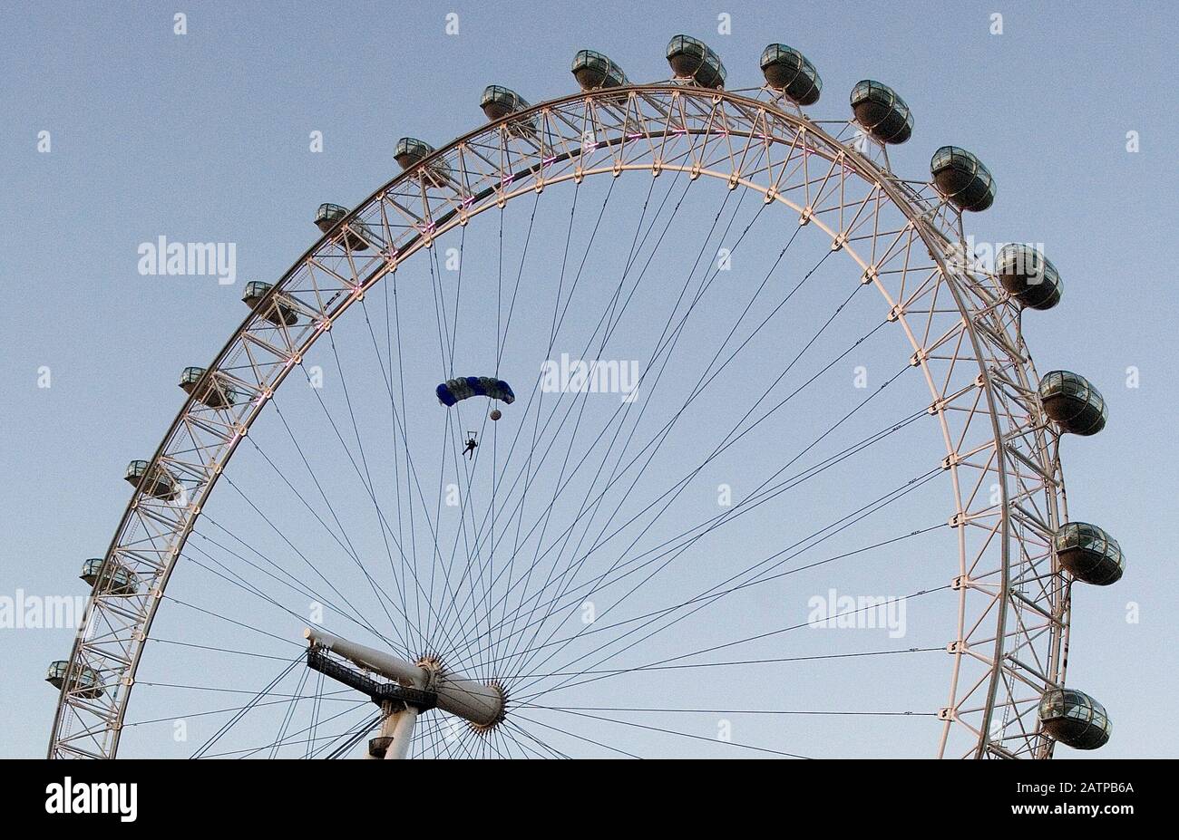 A base jumper leaping from the top of the London Eye at dawn in London 2006. Stock Photo