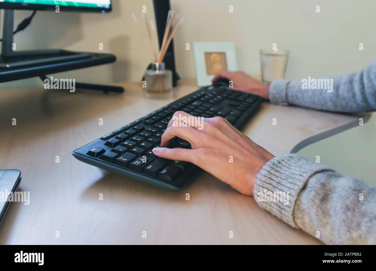 woman typing on wireless keyboard Stock Photo