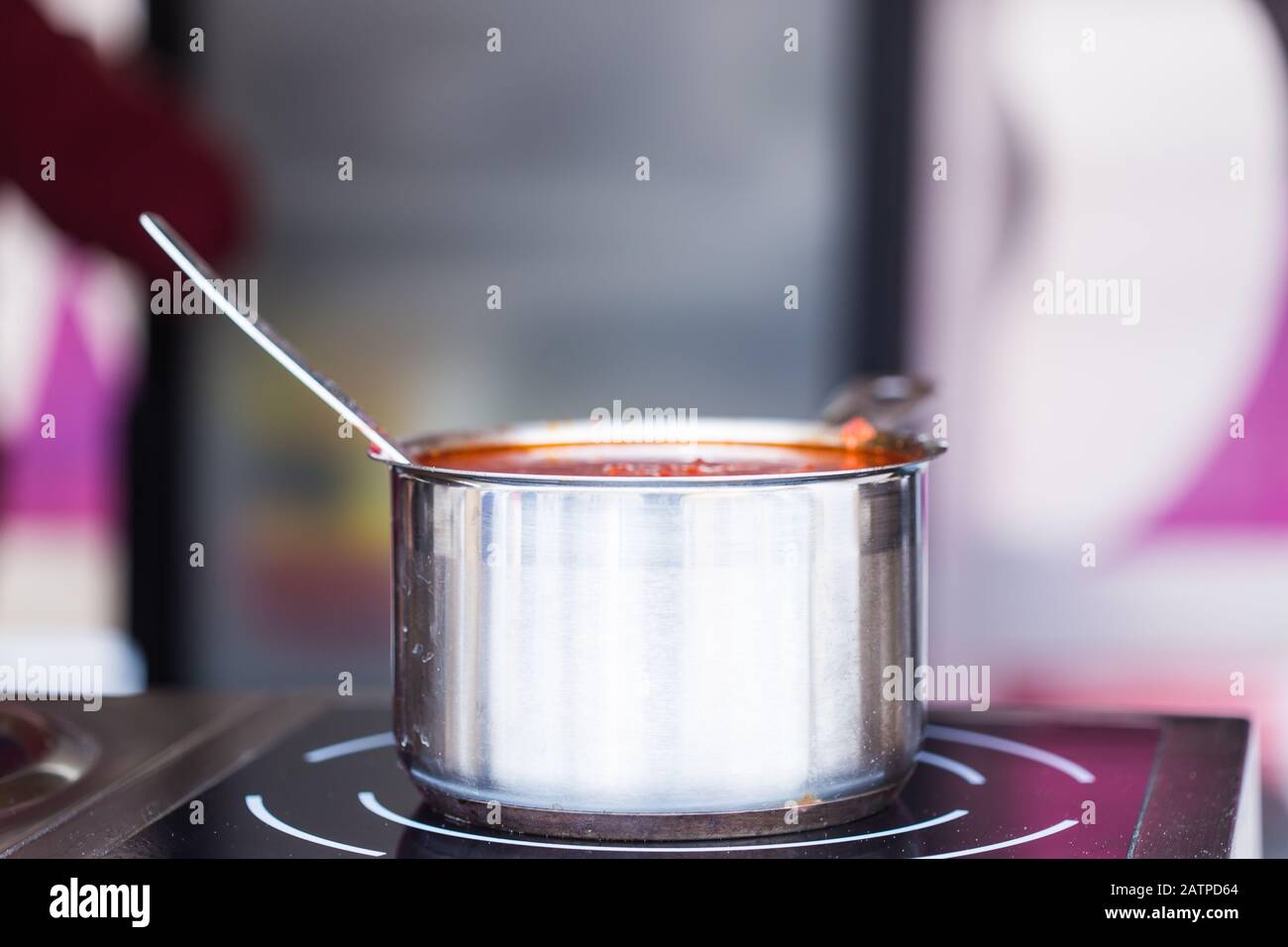 Tomato sauce in metal pan in the kitchen Stock Photo Alamy