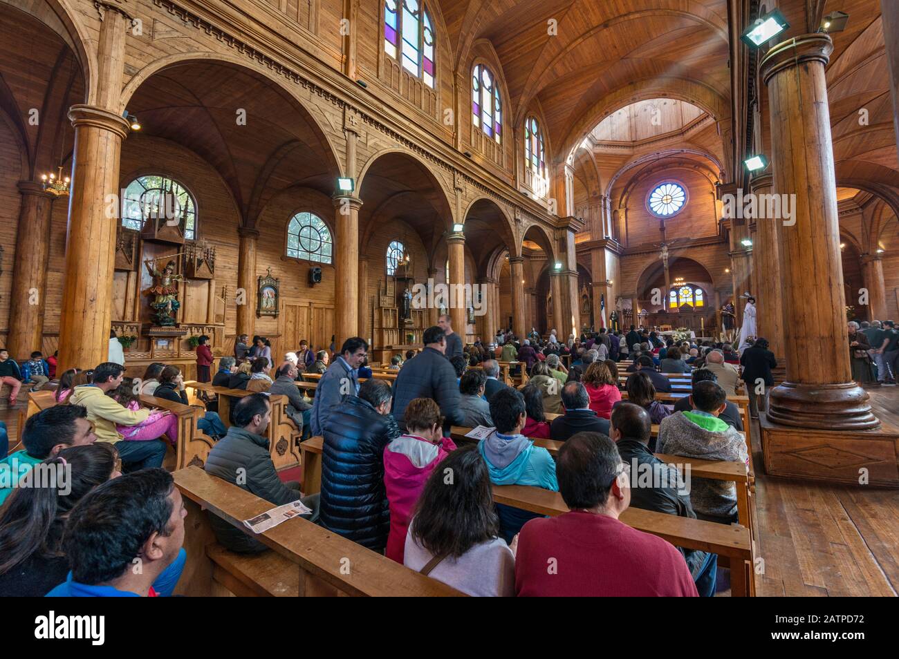 Churchgoers at Easter Mass in Iglesia San Francisco, wooden church in Castro, Isla Grande de Chiloe, Los Lagos Region, Patagonia, Chile Stock Photo