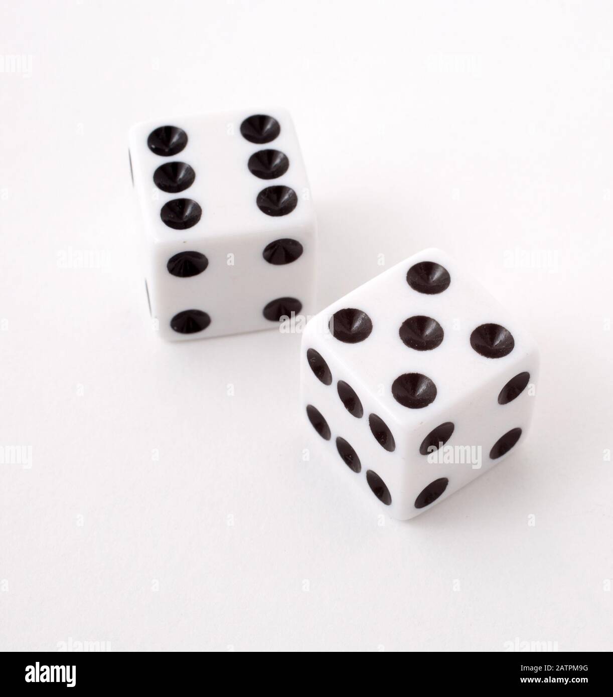 Two dice rolling 11, shot against a white background Stock Photo