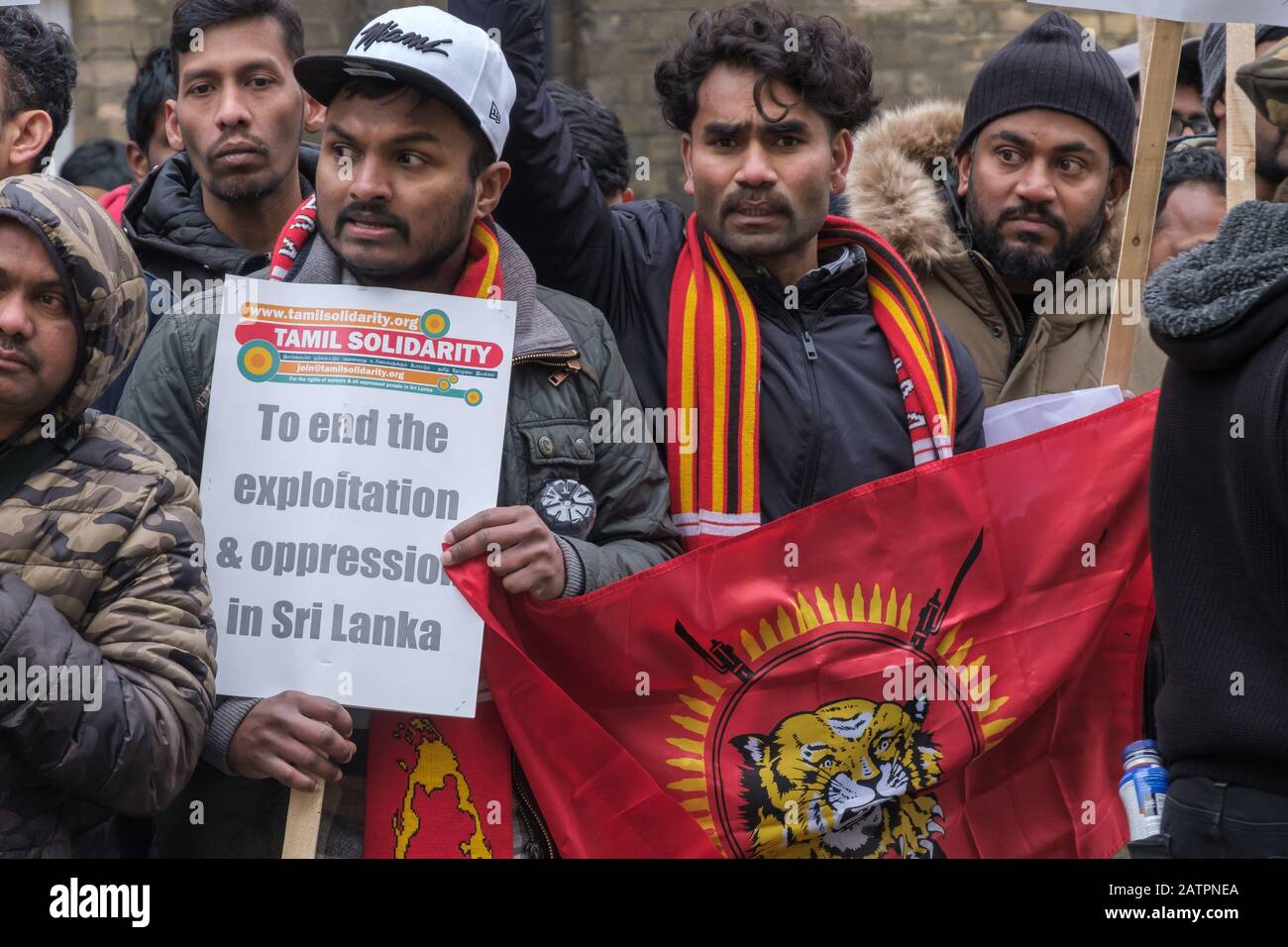 London, UK. 4th February 2020. Protesters with Tamil Eelam flag and scarf. Tamils protest at the Sri Lankan High Commission on Independence Day against the continued denial of the democratic and national rights of Tamils. Sri Lanka now admits the 20,000 Tamils 'disappeared' by the authorities in 2009 are dead and Tamils demand justice and information about their deaths. Credit: Peter Marshall/Alamy Live News Stock Photo