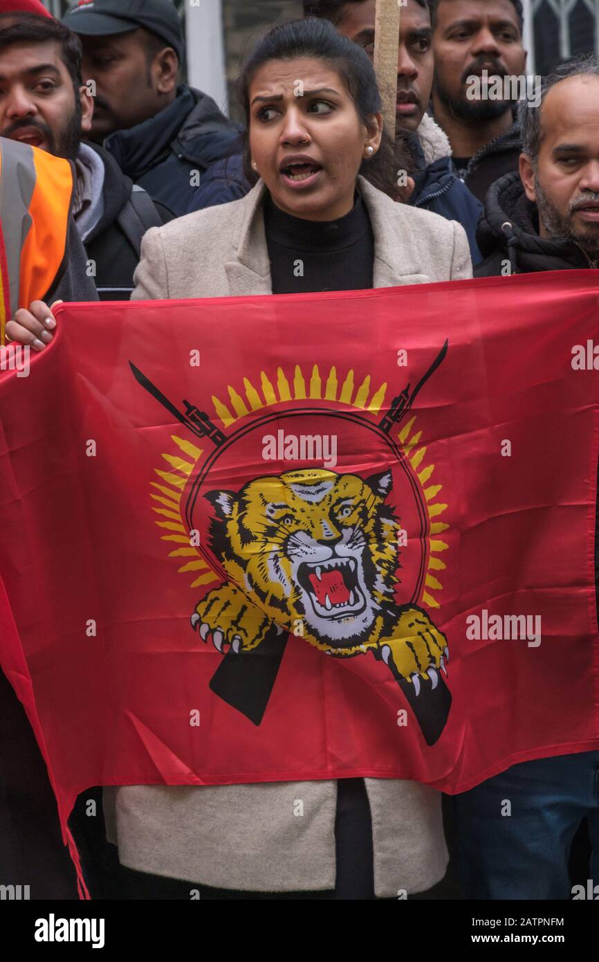 London, UK. 4th February 2020. Woman holds Tamil Eelam flag. Tamils protest at the Sri Lankan High Commission on Independence Day against the continued denial of the democratic and national rights of Tamils. Sri Lanka now admits the 20,000 Tamils 'disappeared' by the authorities in 2009 are dead and Tamils demand justice and information about their deaths. Credit: Peter Marshall/Alamy Live News Stock Photo