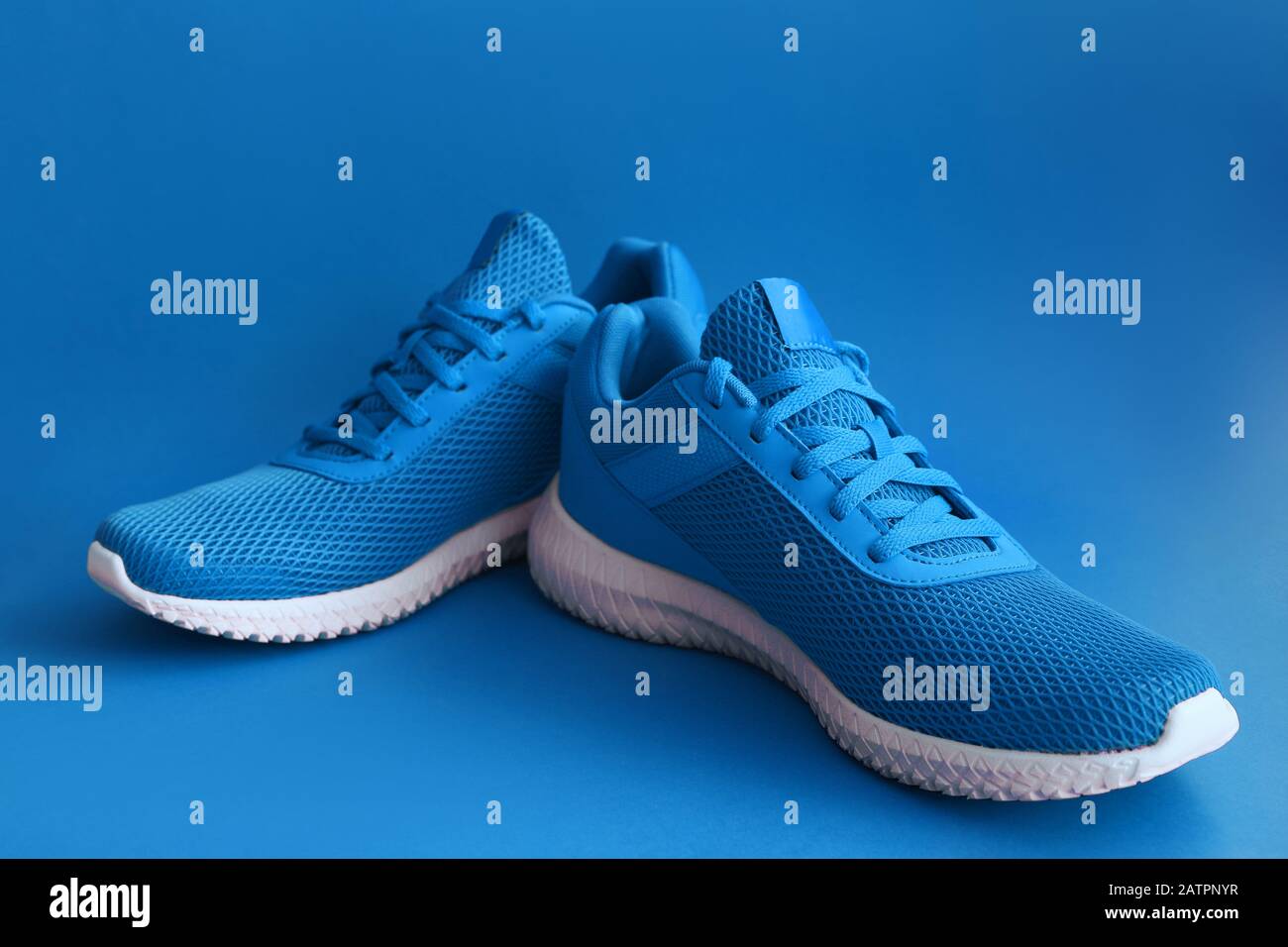 Colorful sport shoes on blue color backround Stock Photo - Alamy