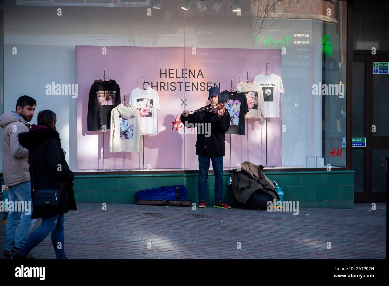 Northampton town centre, a street musician playing a violin busking in  Abington Street in front of H&M window display, England, UK Stock Photo -  Alamy