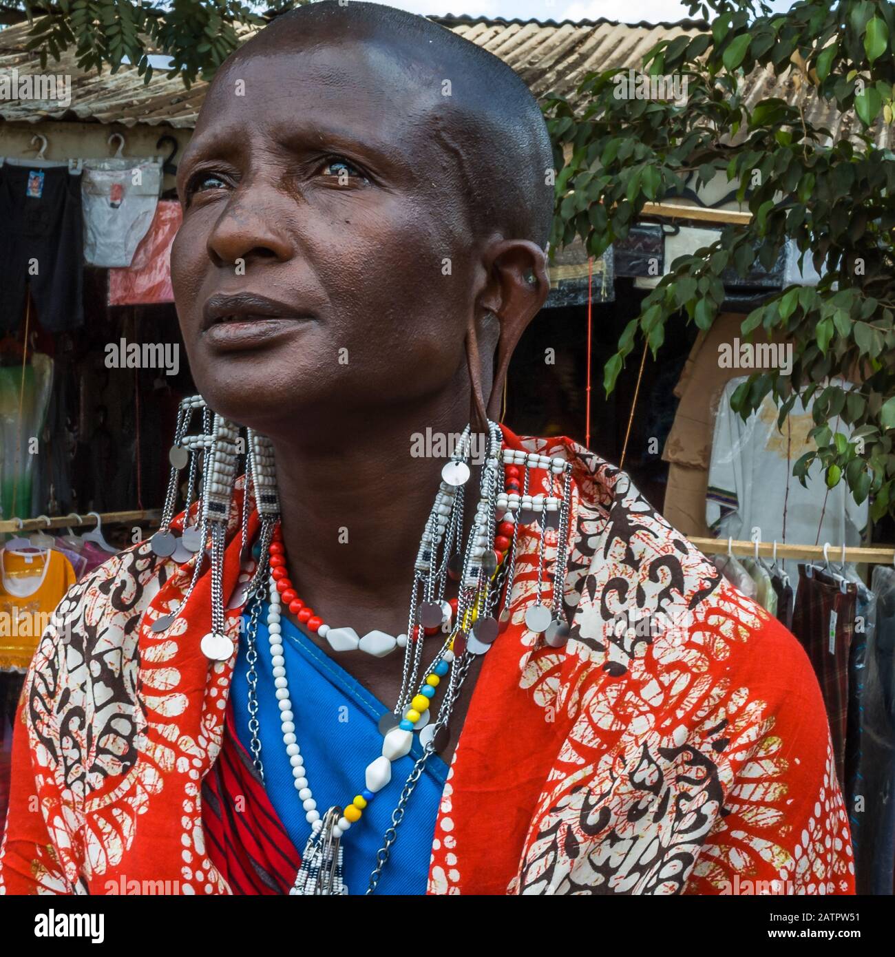A Maasai Lady in the market at Arusha. Ear piercing and the stretching of earlobes are also part of Maasai culture Stock Photo
