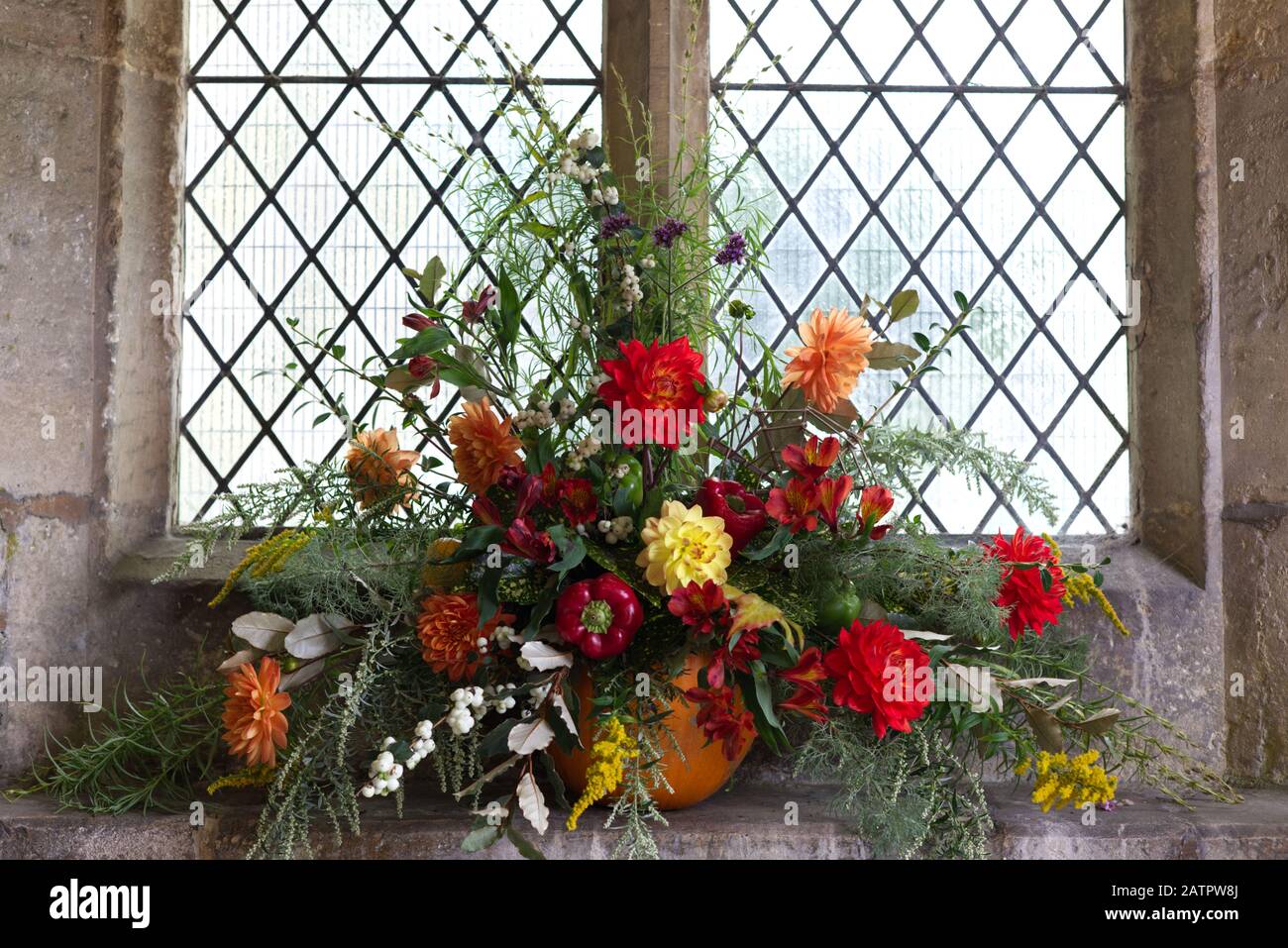 flower display for harvest festival in St Mary's church, Bibury, Gloucestershire Stock Photo