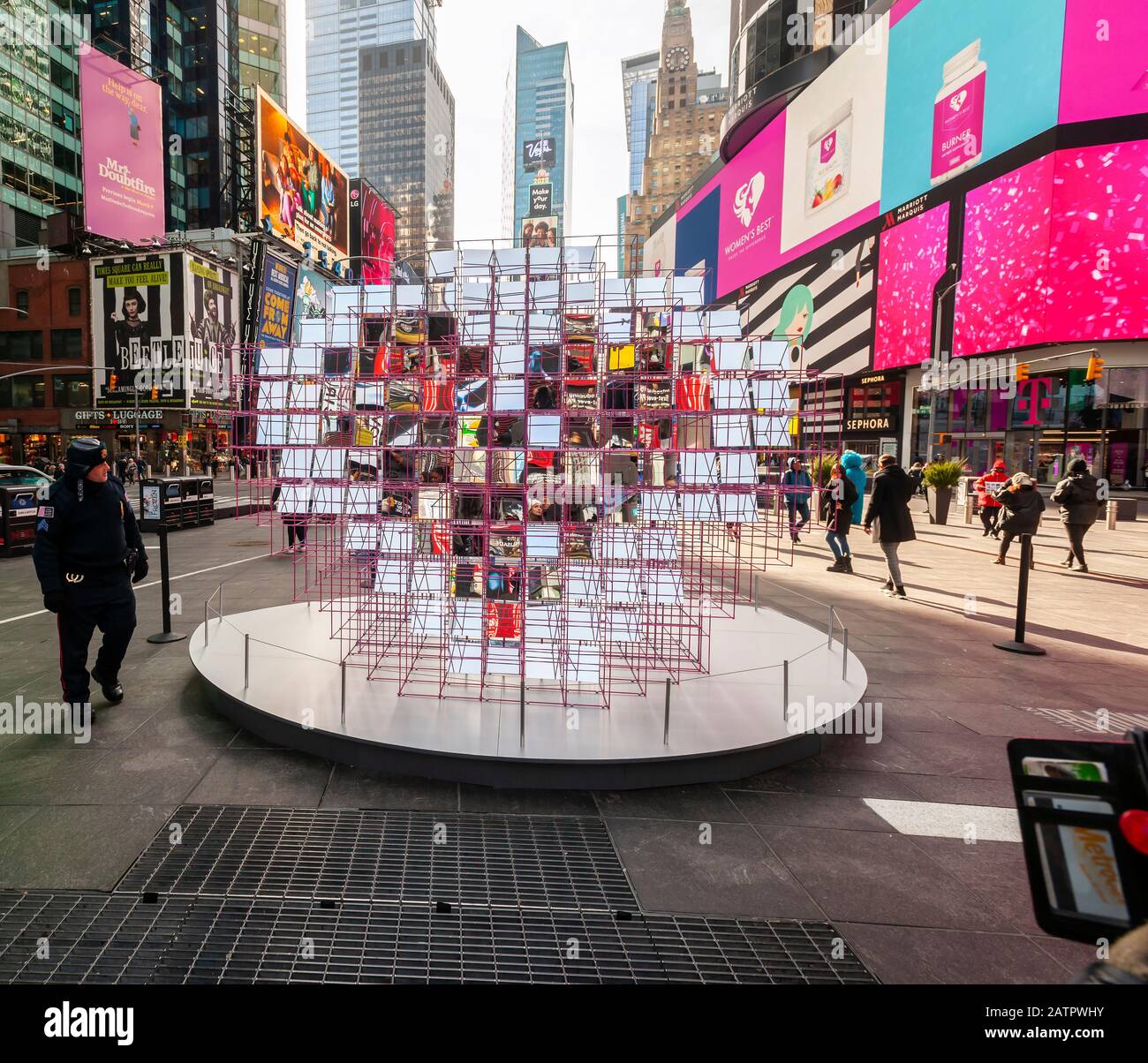 Tourists and the media crowd ÒHeart SquaredÓ, the winner of the 12th Annual Times Square Valentine Heart Design in Times Square in New York, at its unveiling on Thursday, January 30, 2020. Created by MODU and Eric Forman Studios the sculpture consists of 125 mirrors precisely aligned to reveal a kaleidoscopic heart. The installation will be on view throughout February. (© Richard B. Levine) Stock Photo