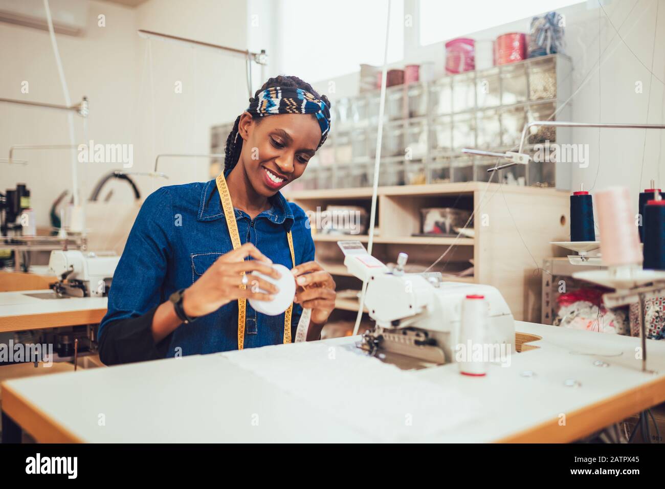 Woman seamstress working on industrial hi-res stock photography and ...