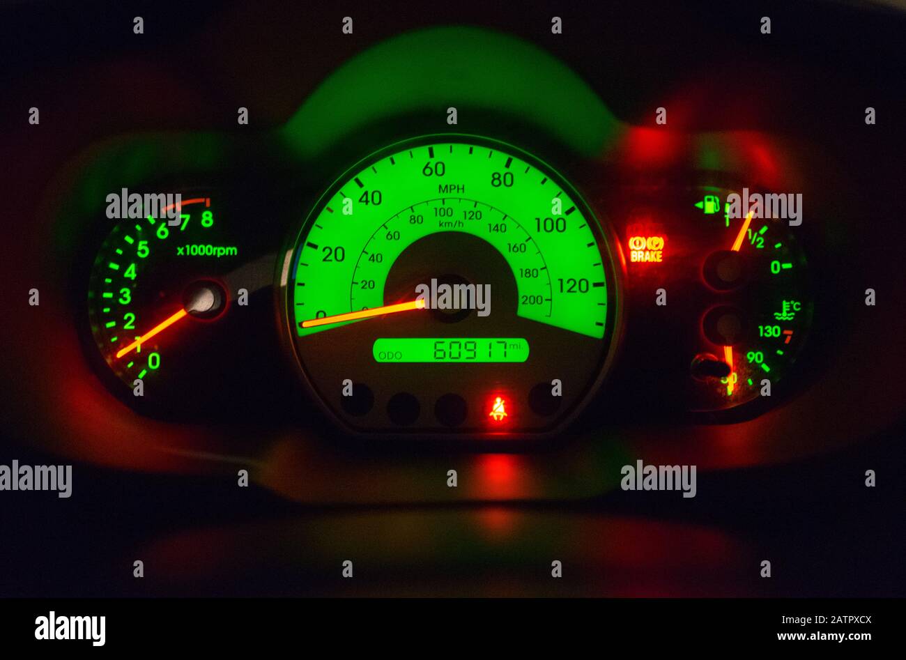 Hyundai i10 speedometer dashboard looking through the steering wheel lit up  at night Stock Photo - Alamy