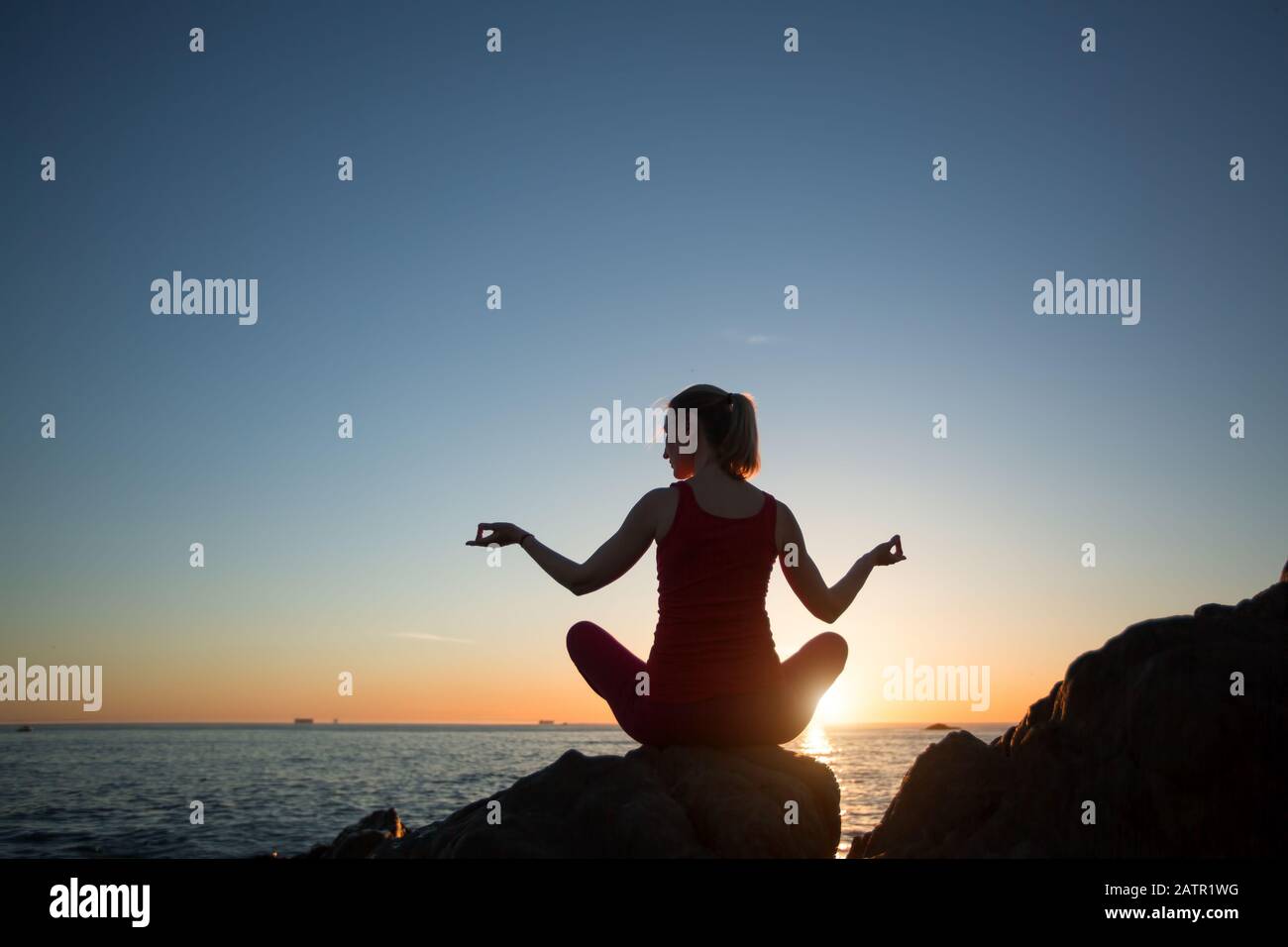 Silhouette of yoga woman during sunset on the ocean beach Stock Photo ...