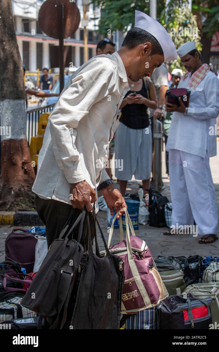 India, Mumbai aka Bombay. Dabbawalas (aka dabbawallas or dabbawallahs, tiffin wallahs) deliver lunches all over the city every day. Stock Photo