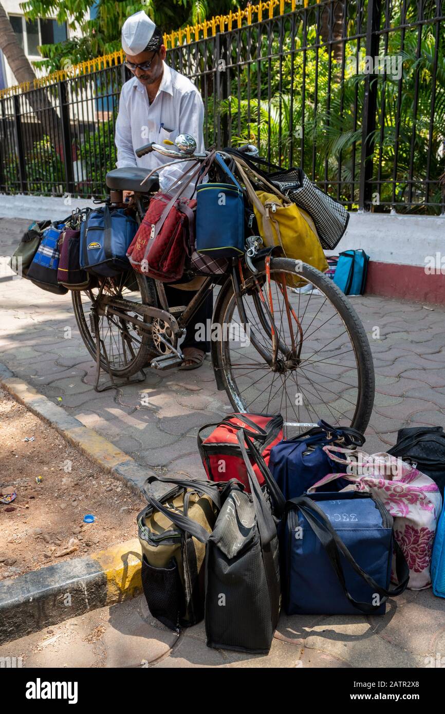 India, state of Maharashtra, capital city of Mumbai aka Bombay. Dabbawalas (aka dabbawallas or dabbawallahs, tiffin wallahs) deliver lunches. Stock Photo