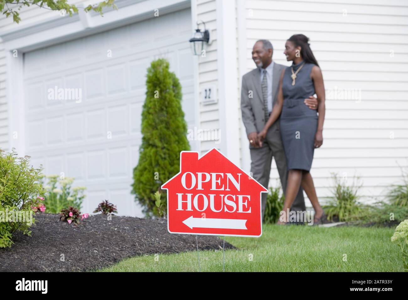 Middle-aged couple walking in front of a house and smiling Stock Photo ...