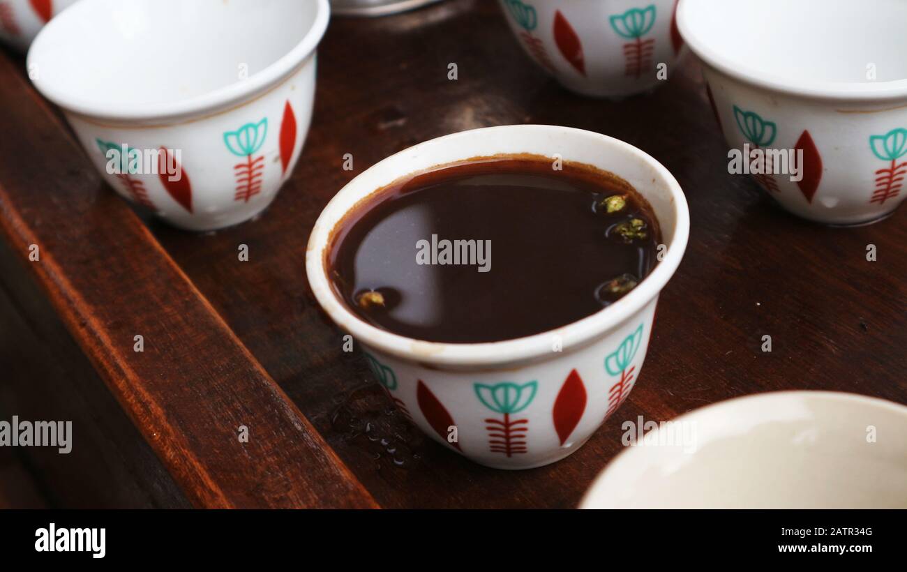 Ethiopian coffee in traditional small coffee cup with cardamom seeds