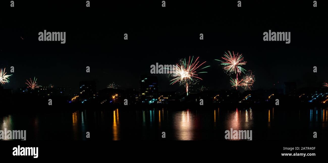 2020 New Year colorful fireworks exploding on the sky above Lacul Morii Lake, Bucharest, Romania - 1/1/2020. Stock Photo