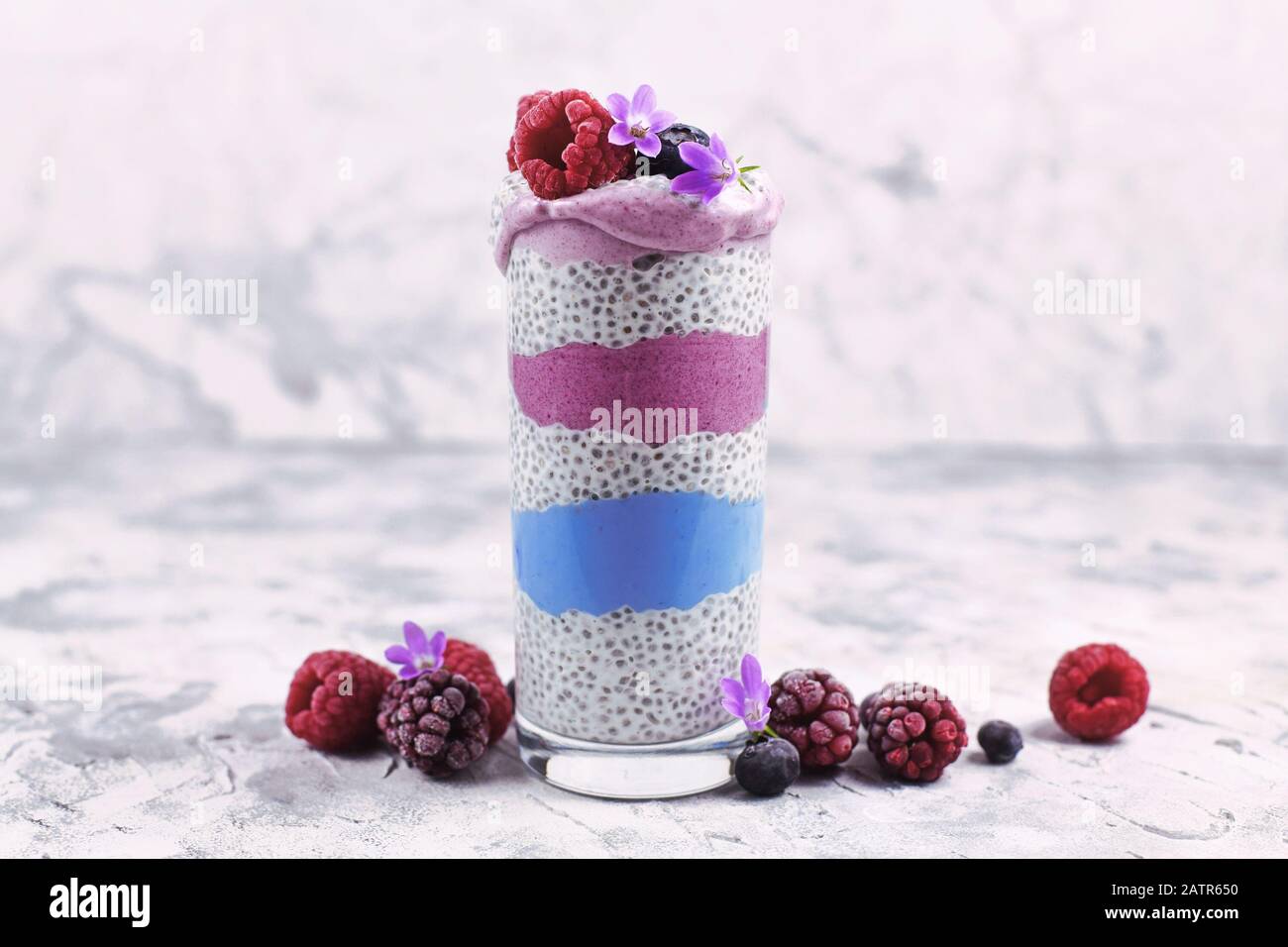 Healthy layered smoothie with natural colored fruit and chia seed ...
