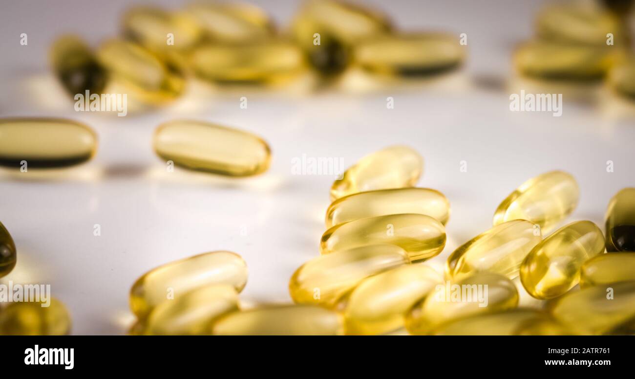 Fish Oil Omega 3 golden capsules on black blackground Stock Photo Alamy