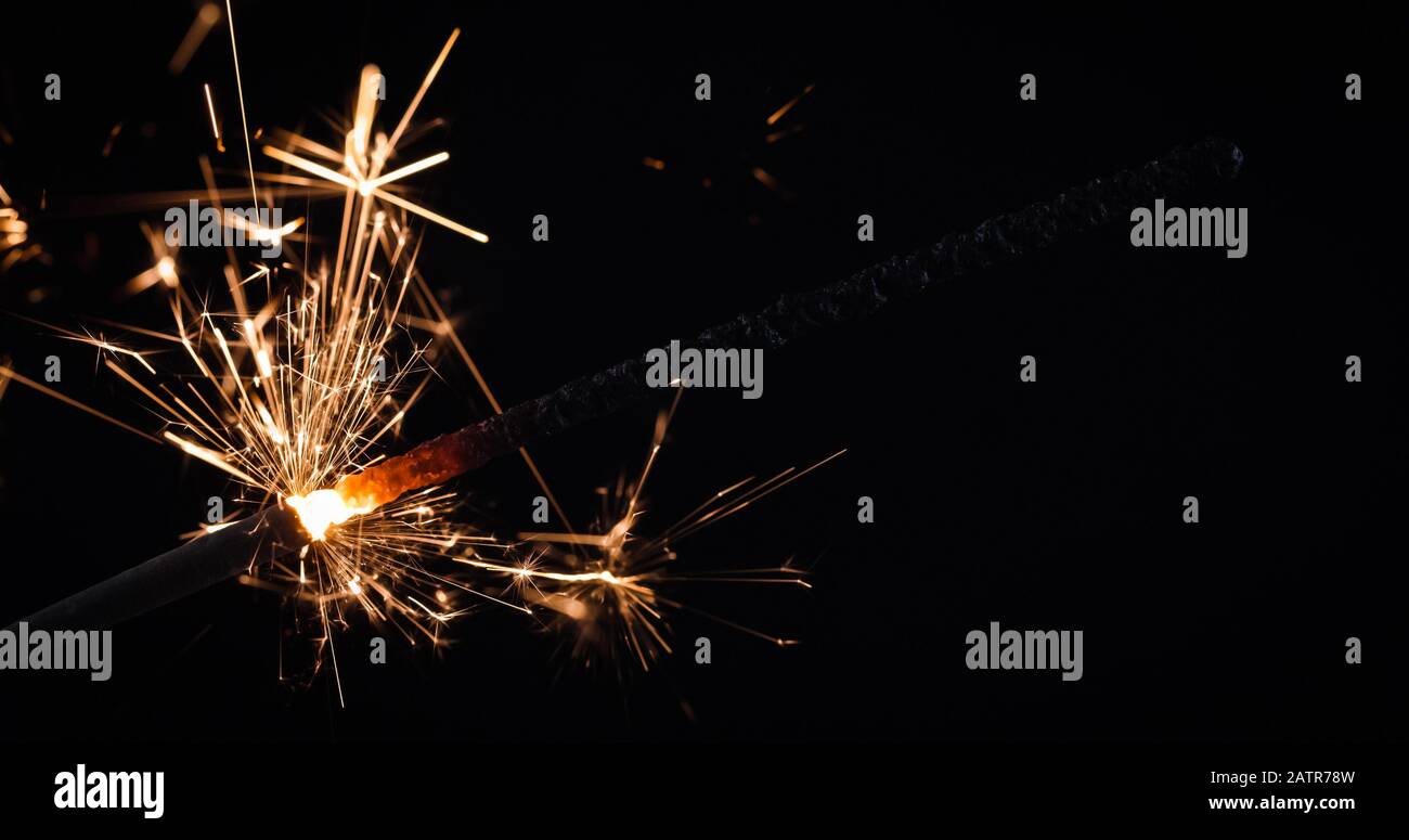 Firework festive sparkler burning on black background Stock Photo