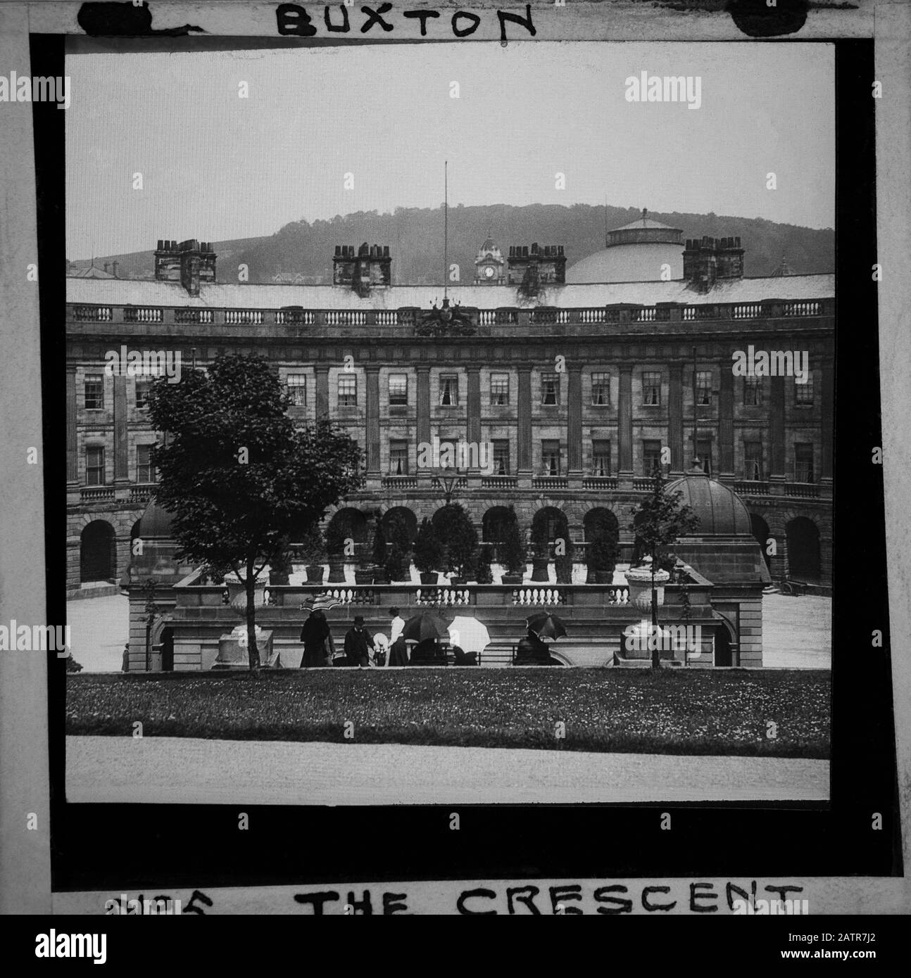 Buxton Crescent & Thermal Spa Hotel during the Victorian period c1890, Victorians in front of the Bath House, antique old glass magic lantern slide picture. The newly renovated hotel is due to open in 2020 creating a northern capital for health and wellbeing. Antique Magic Lantern Slide.  Original photographer unknown, copyright period expired.  Digital photography, restoration, editing copyright © Doug Blane. Stock Photo