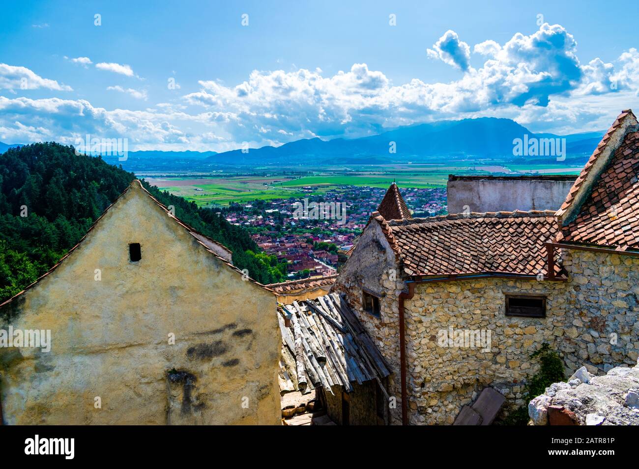 Landscape photo taken from the Rasnov Citadel showing the Rasnov city and the mountains in the distance - Rasnov, Brasov country, Transylvania, Romani Stock Photo