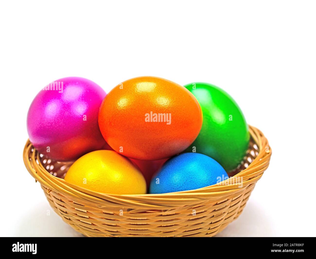 Colorful Easter eggs in basket against white background Stock Photo - Alamy