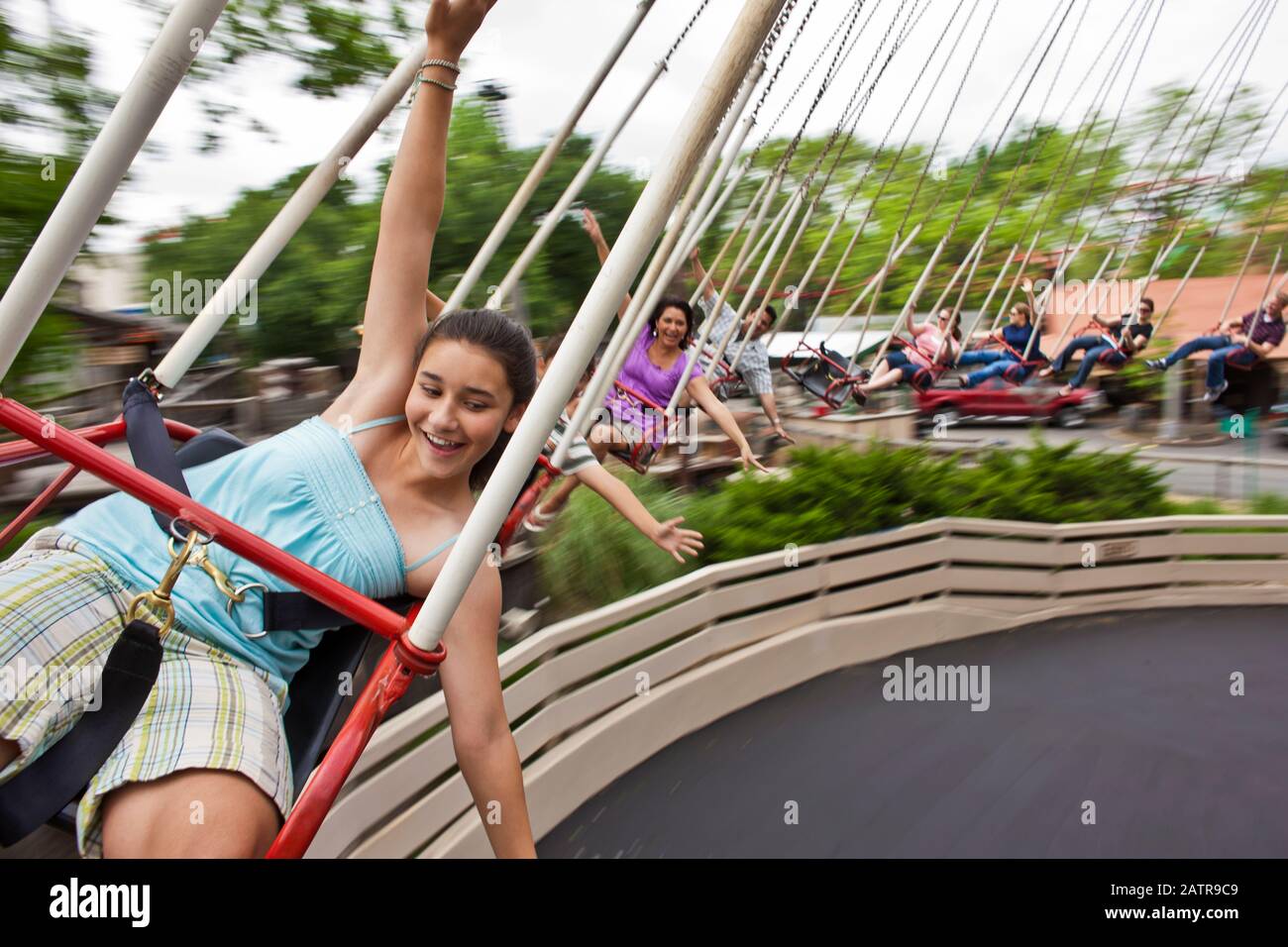 Someone On Ride Happy people on a swing ride at an amusement park Stock Photo - Alamy
