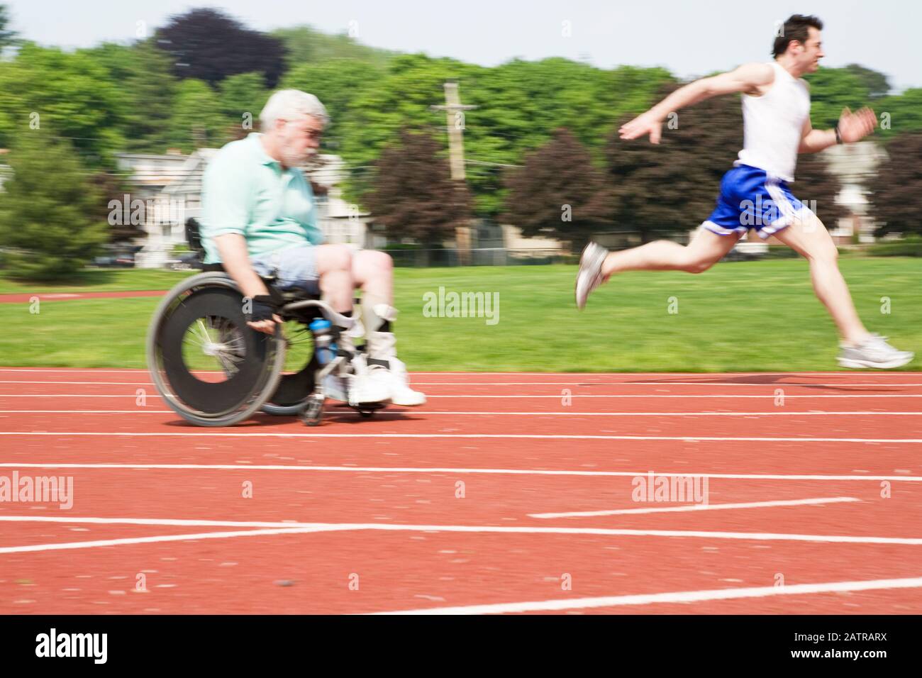 Young man racing with a handicapped senior man on a racetrack Stock ...