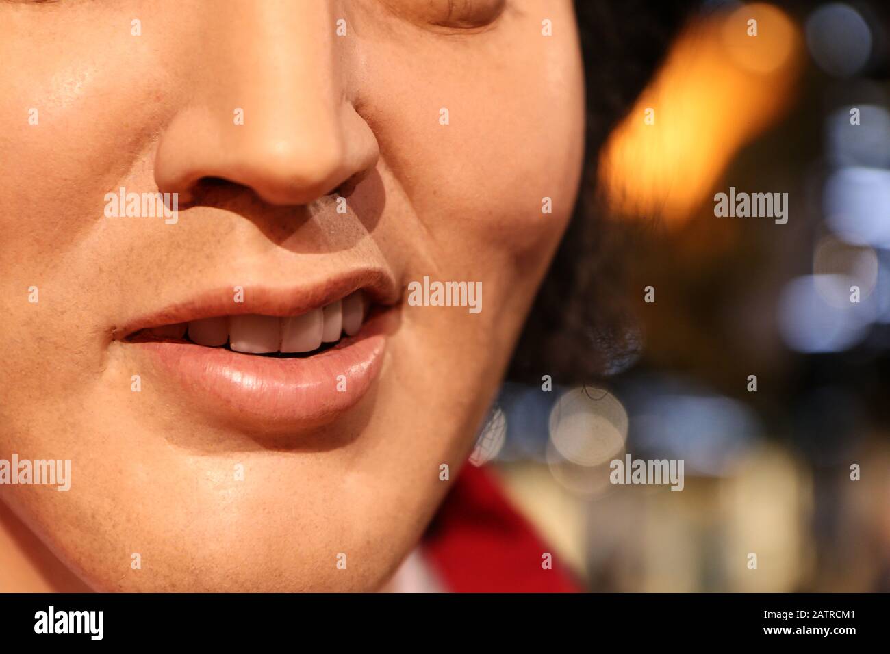 The detail of the smile of the wax figurine of Elvis Presley. Stock Photo
