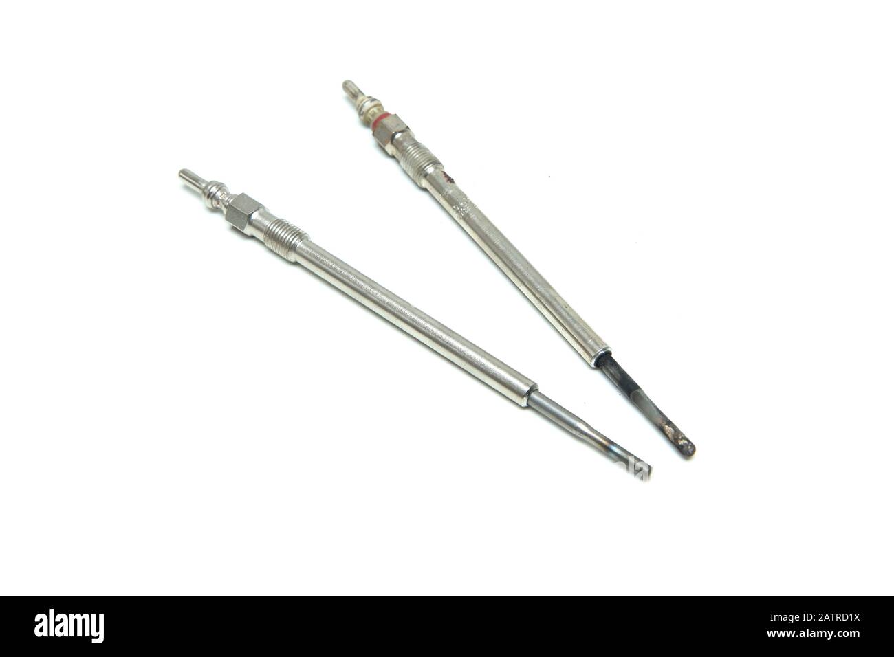 The two glow plugs for diesel engines isolated on a white background. One  is old, used and non functional and one is new Stock Photo - Alamy