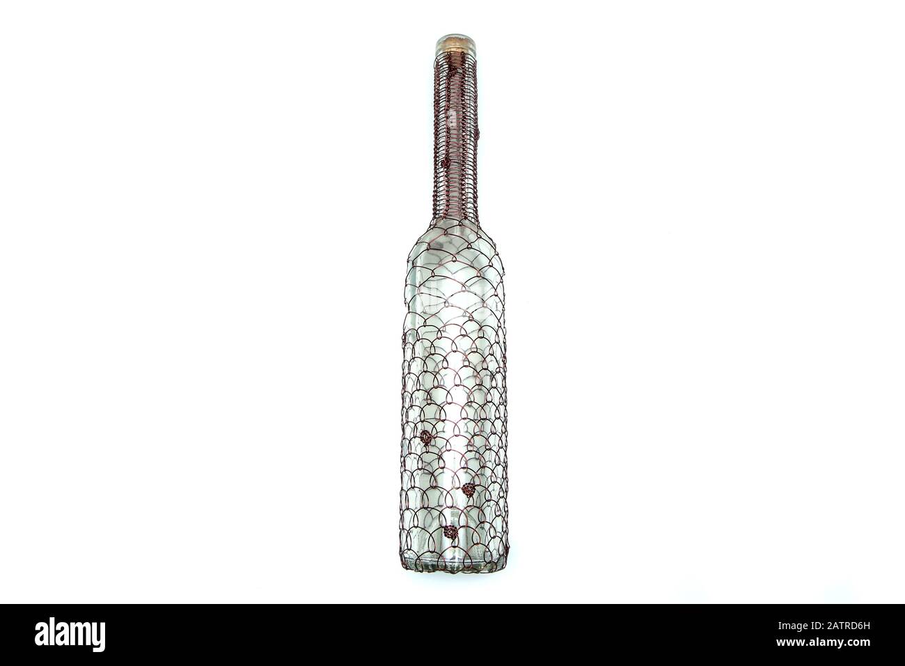 The wire brushed wine bottle.  The traditional decorative craft. In a white background. Stock Photo